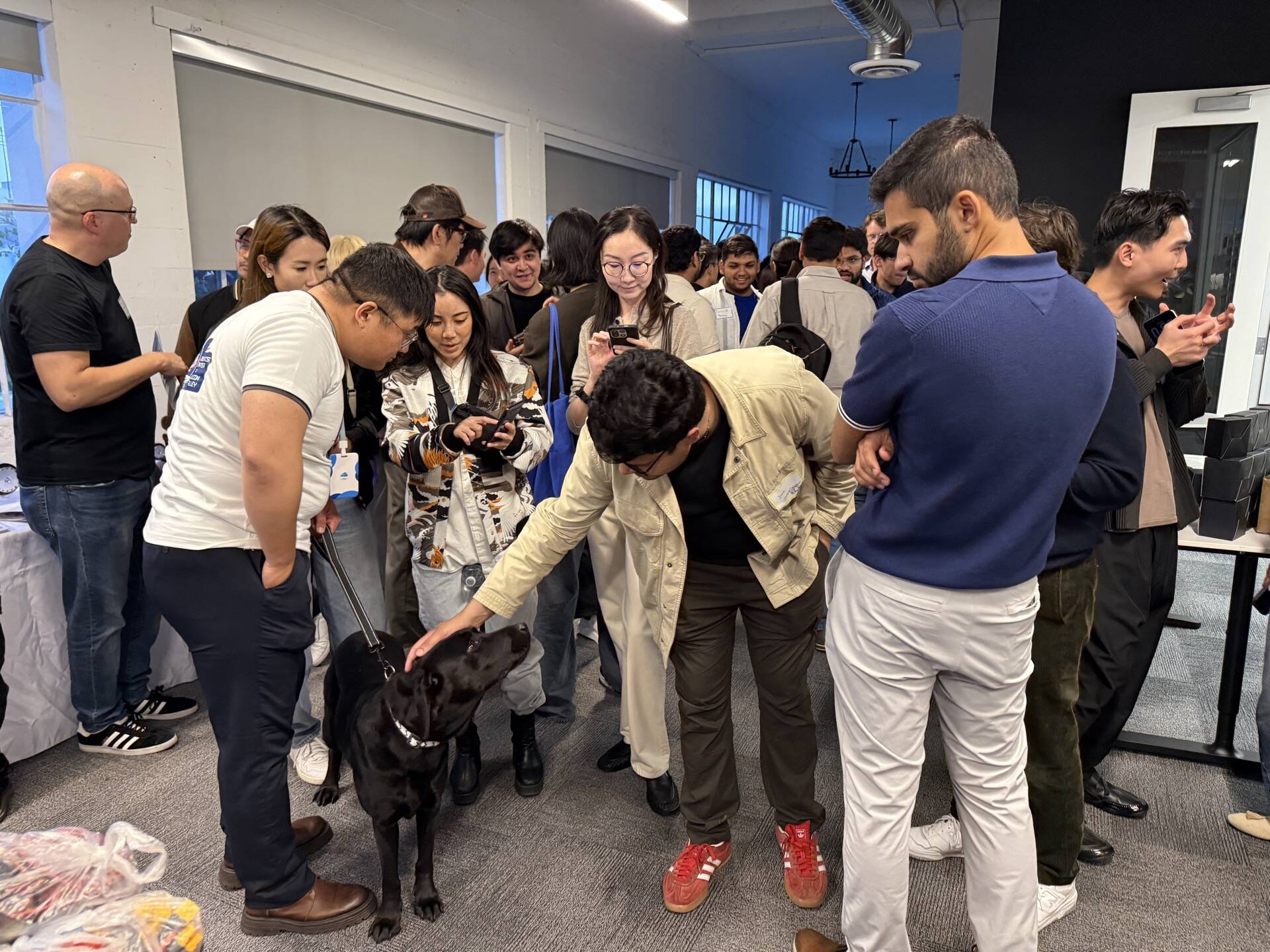 Crowd gathered around robot dog demo at SVRC May 2026 robotics meetup San Francisco